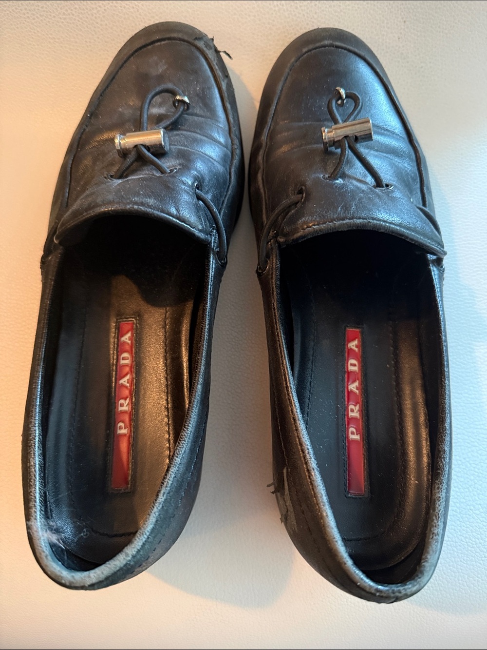 Prada Black Leather Woman’s Slip-On Loafers with Metal Toggle